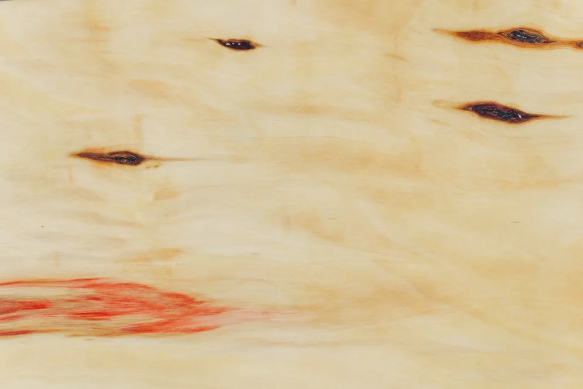 Abstract soft beige and pink watercolor texture with subtle dark accents.