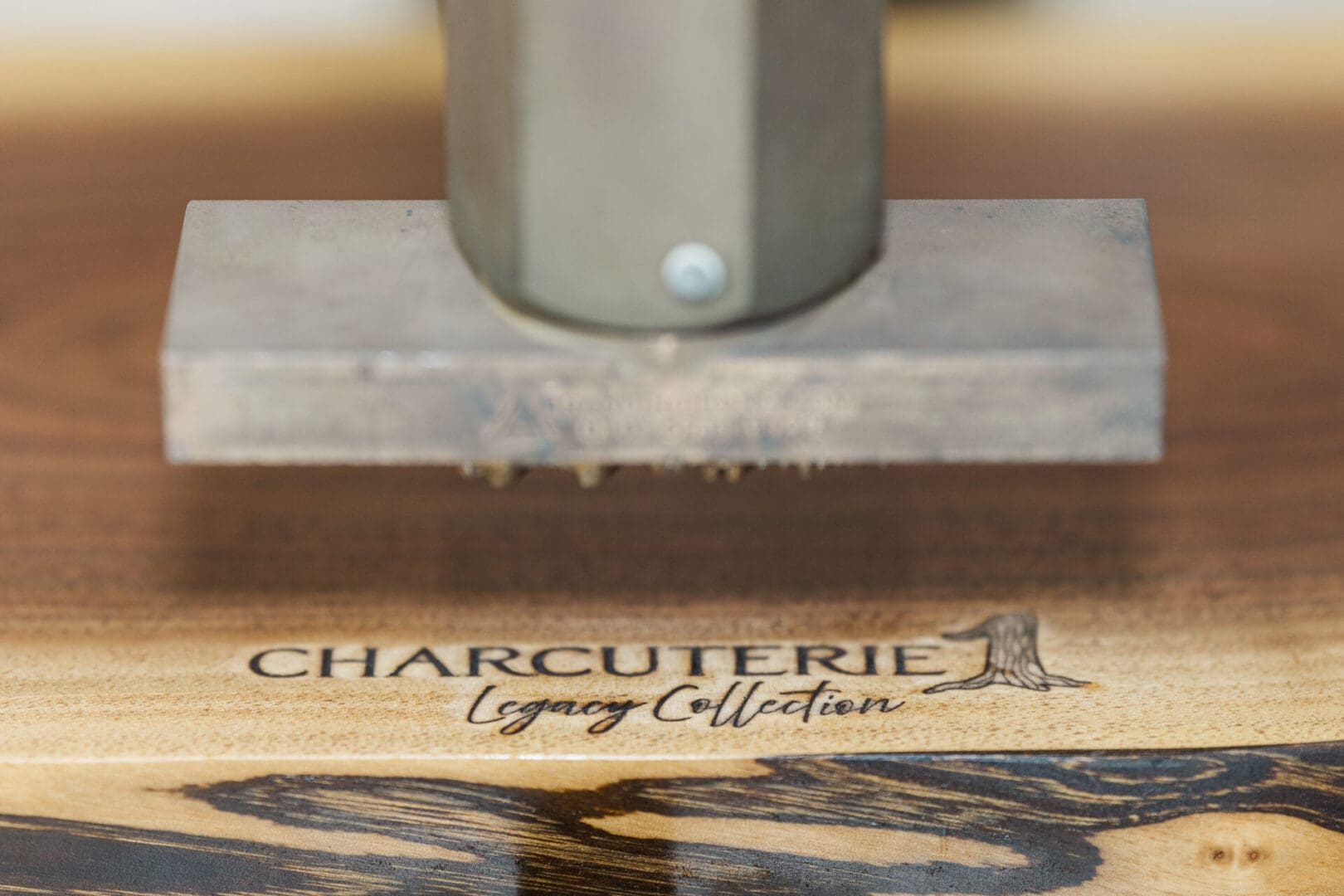 Wooden charcuterie board with engraved text and a small Eiffel Tower design.