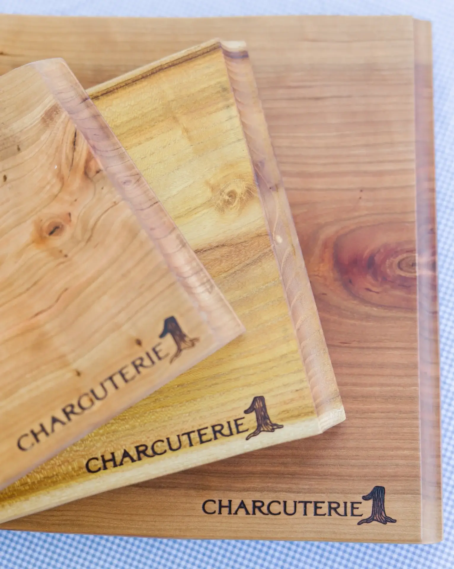 Wooden charcuterie boards with engraved text and a small silhouette of a dog.