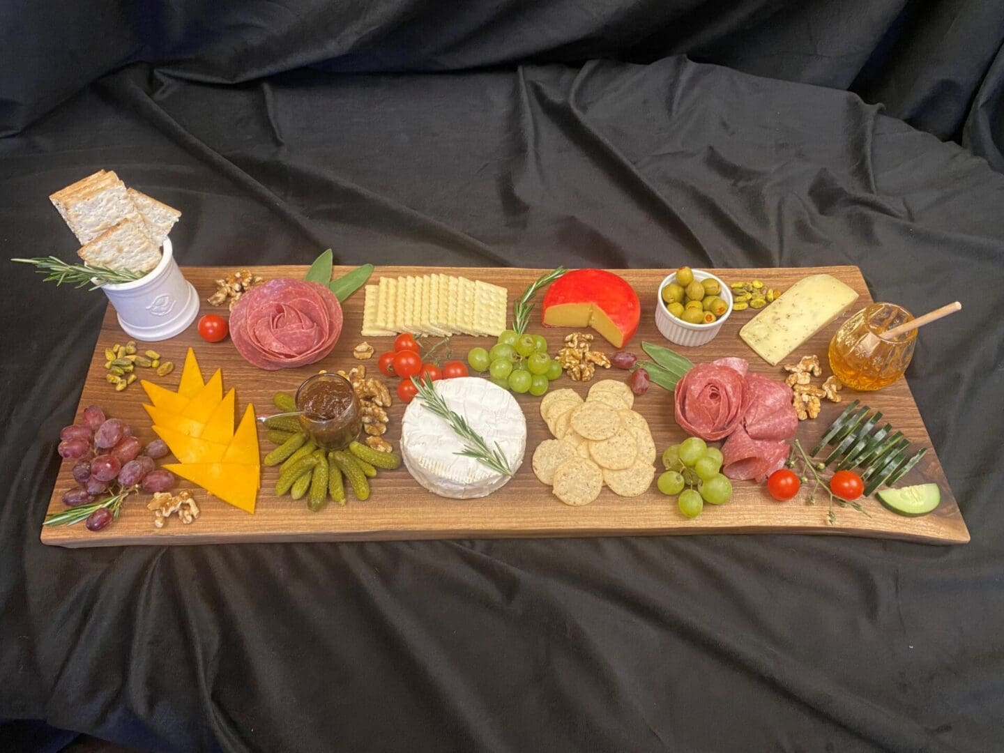 Charcuterie board with cheese, meats, and fruits.