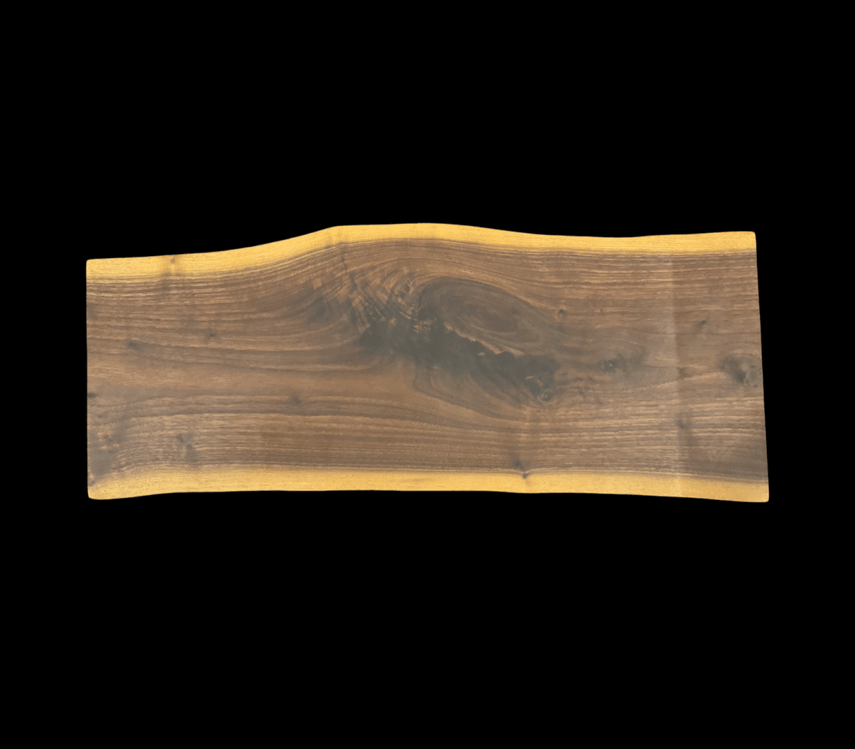 Wooden slab with natural edges, black background.