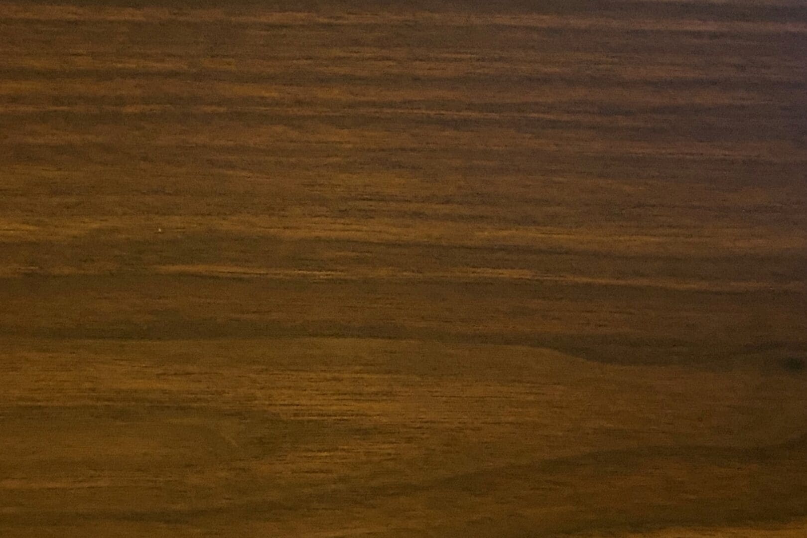Dark brown wooden texture surface close-up.